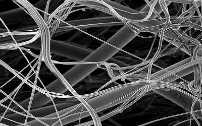 From Lab to Pilot Scale: Melt Electrospun Nanofibers of Polypropylene with Conductive Additives